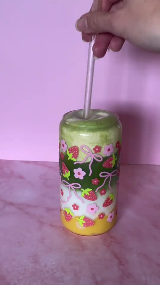 Iced matcha in a floral glass on a pink set